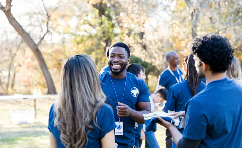 A group of volunteers chats before starting a job. Learn more about reshaping volunteerism in this guide. 