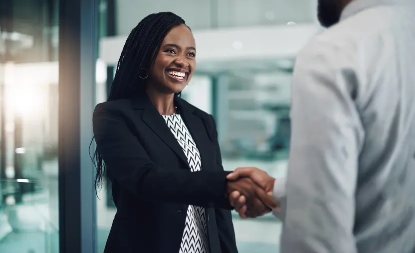 Capturing CRA service credits for banks can help them build connections with the community, like these two colleageus shaking hands.
