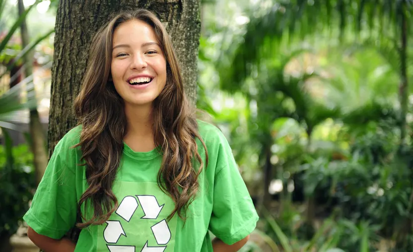 young volunteer: environmentalist in the forest wearing a green recycling T-shirt