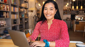 A woman uses her laptop to promote matching gifts for her nonprofit online.