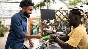 Man paying using contactless payment in a garden store