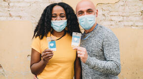 Two masked frontline workers pose together, knowing they are supported by Bonterra Program management.