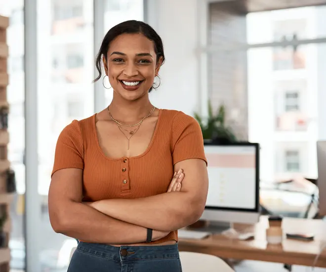 Portrait of an attractive and confident young businesswoman posing with her arms folded inside an office