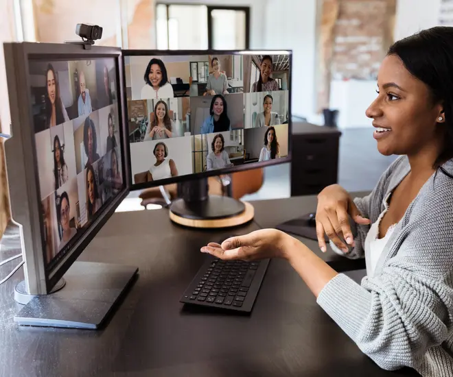 Adult woman teleconferences to meet with her diverse colleagues