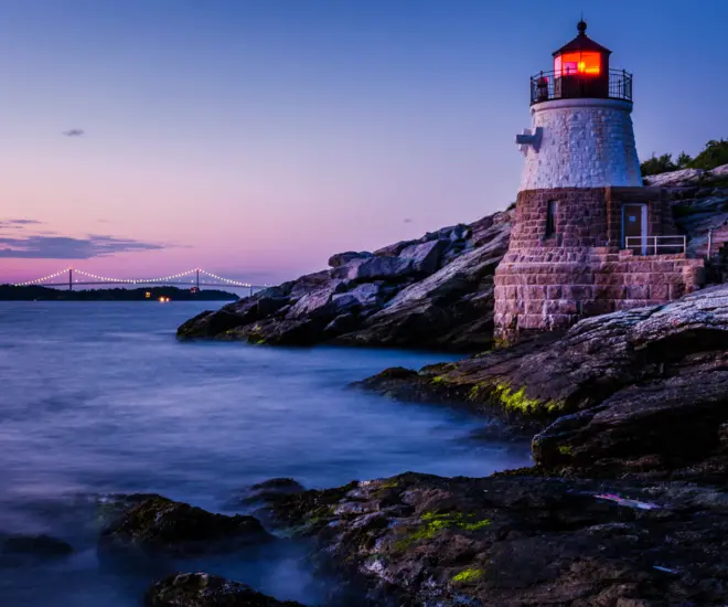 A lighthouse and the Newport bridge in Rhode Island. 