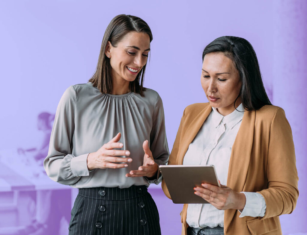 Two individuals collaborating on an actionable annual report.