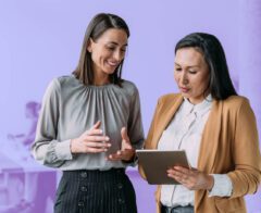 Two individuals collaborating on an actionable annual report.