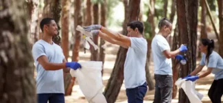 Employees from the same company volunteering in a public site clean up.