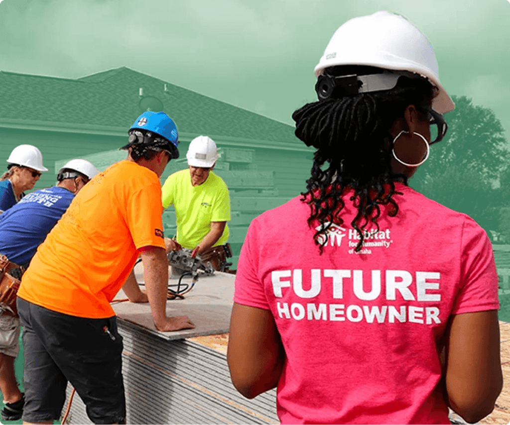 Woman wearing a 'Future Homeowner' shirt and hard hat at a construction site with Habitat for Humanity volunteers.