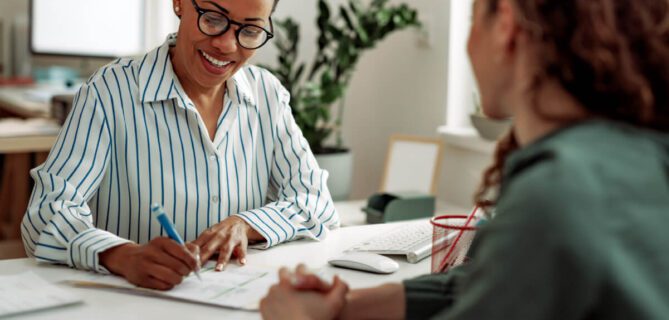 A photo of nonprofit case management, where two people are sitting down for a meeting.