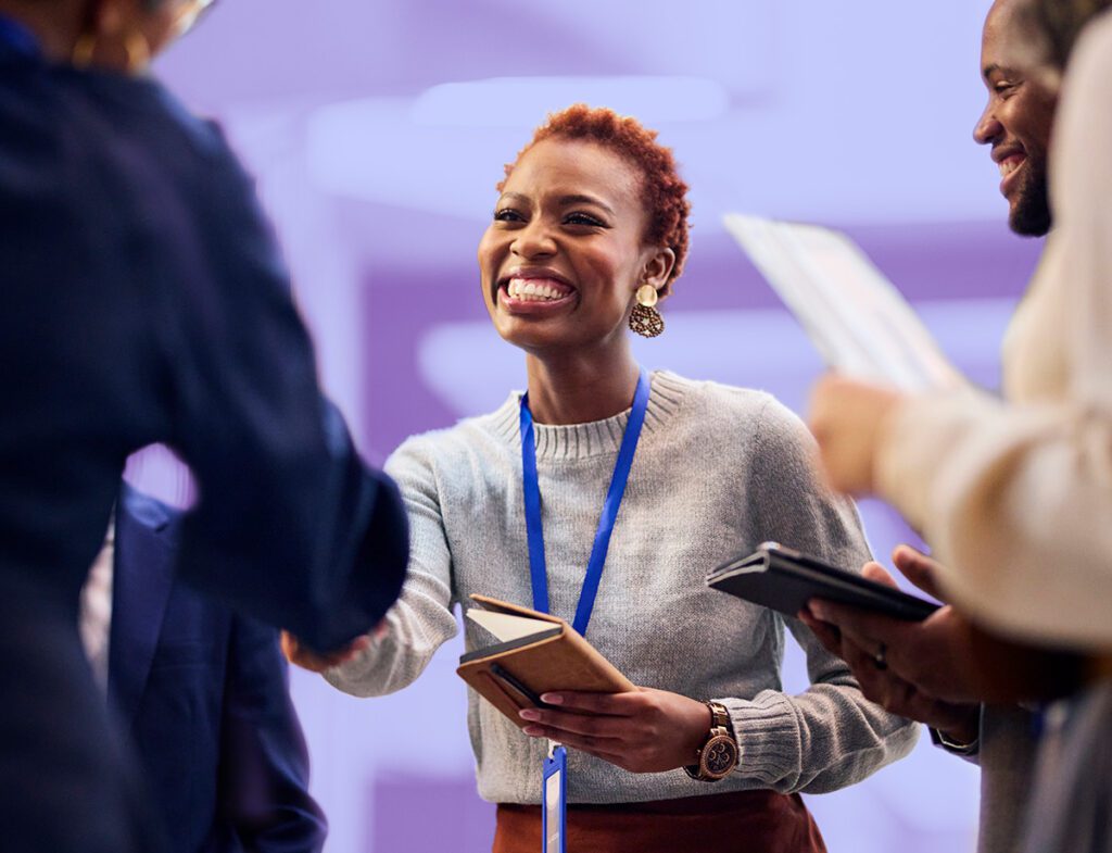 A photo of two people shaking hands at a networking event.
