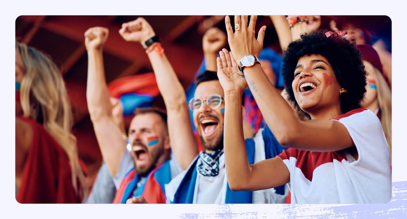 Stock photo of people celebrating at a sports game.