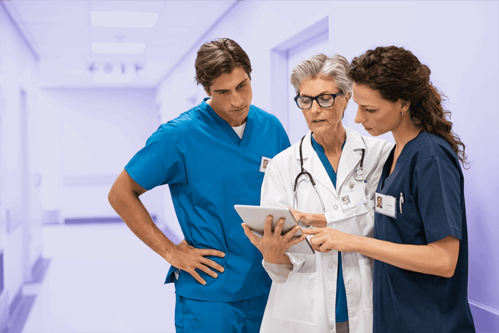 Three medical professionals reviewing their CyberGrants for Life Sciences medical grantmaking software.