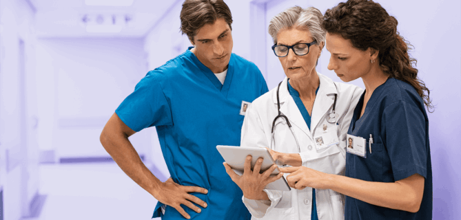 Three medical professionals reviewing their CyberGrants for Life Sciences medical grantmaking software.