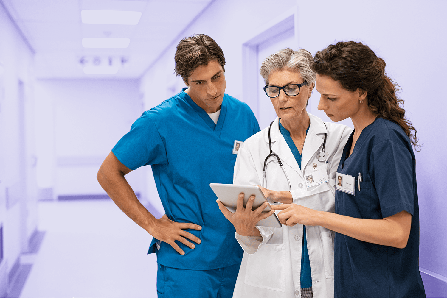 Three medical professionals reviewing their CyberGrants for Life Sciences medical grantmaking software.