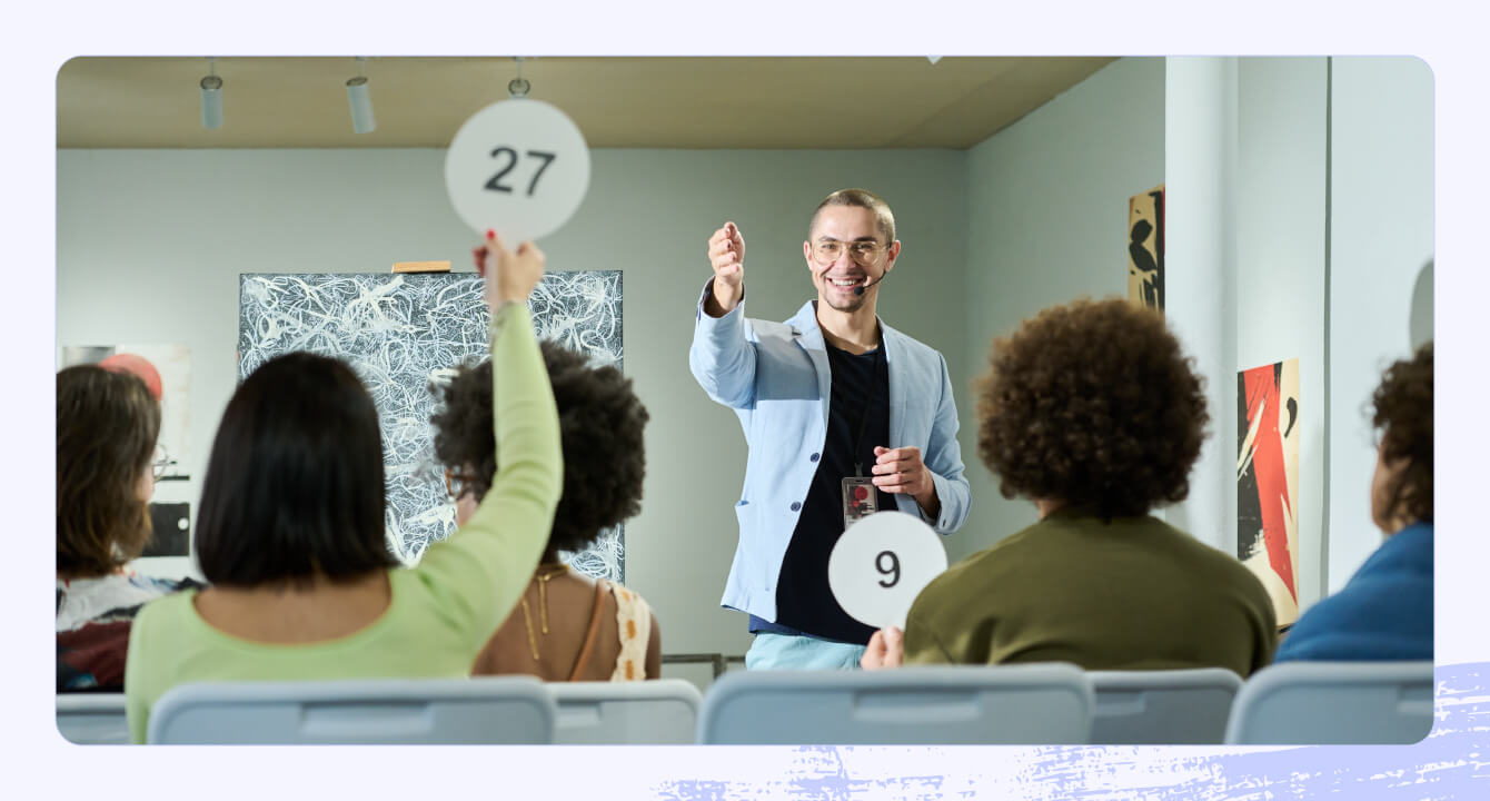 Stock photo of a crowded room with an auction occurring.