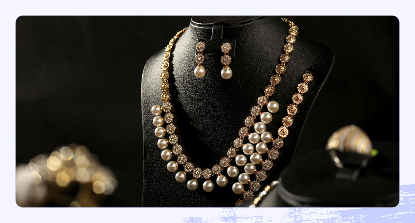 Elegant diamond necklaces on blue velvet display.