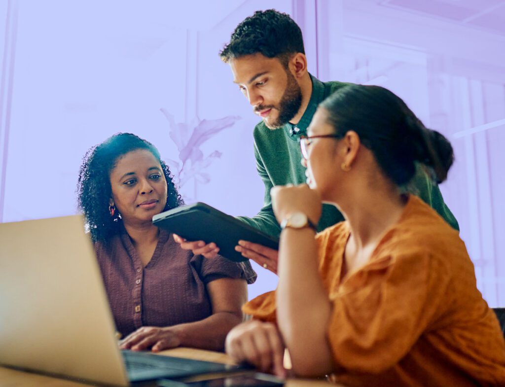 A photo of a team working together using nonprofit case management software.