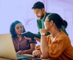 A photo of a team working together using nonprofit case management software.