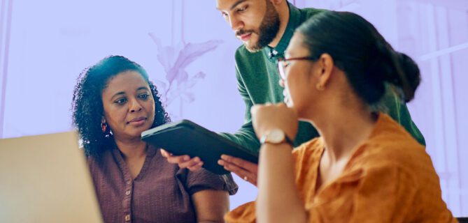A photo of a team working together using nonprofit case management software.
