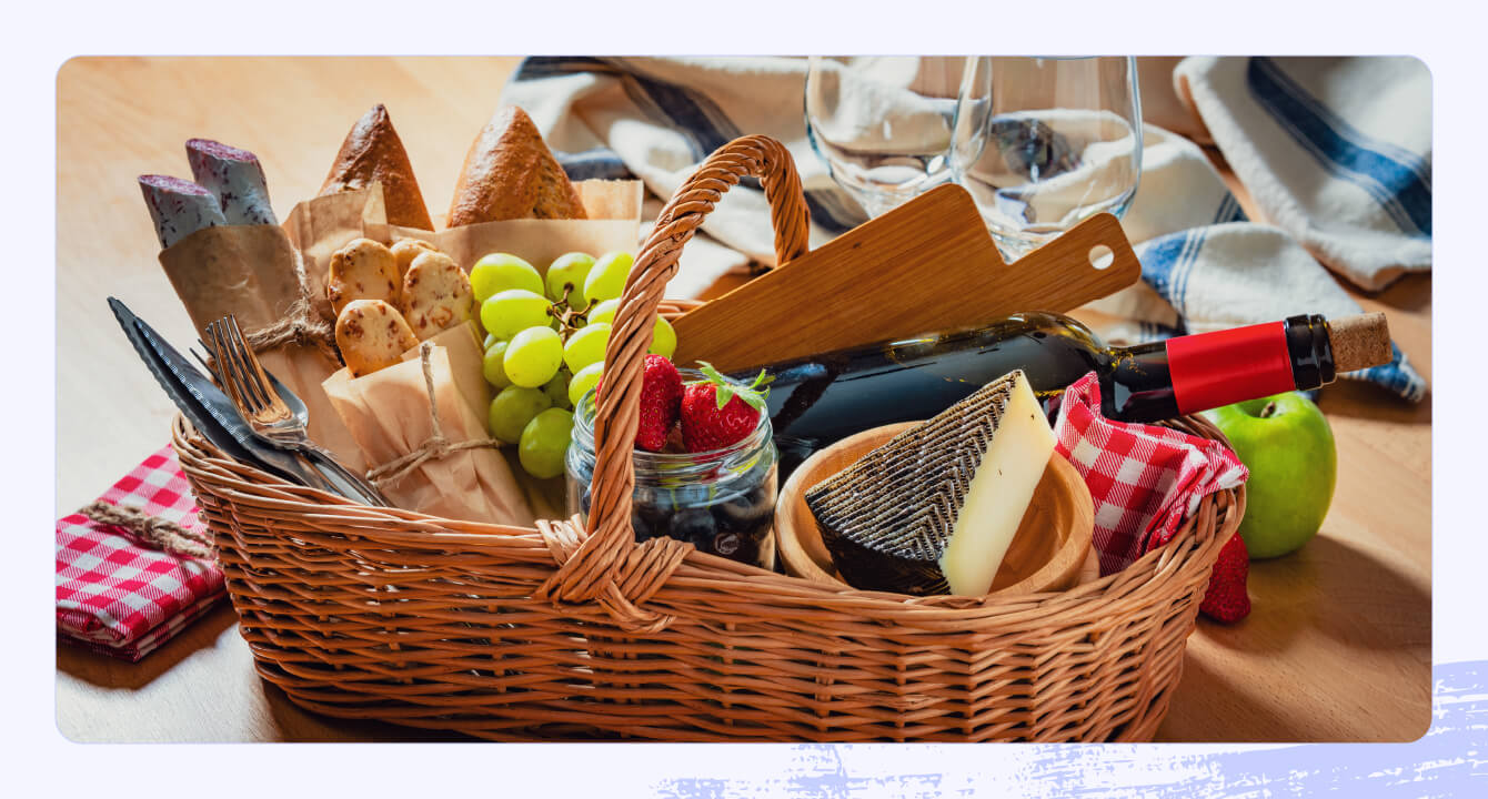 Stock photo of a picnic basket with wine and cheese.
