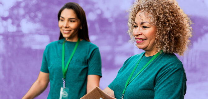 A picture of two people volunteering for a nonprofit.