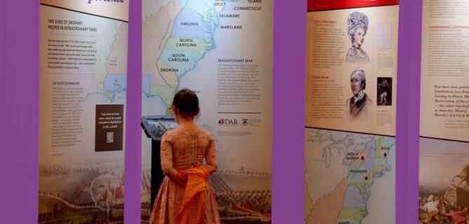 Young girl reading exhibit panels about the American Revolution.