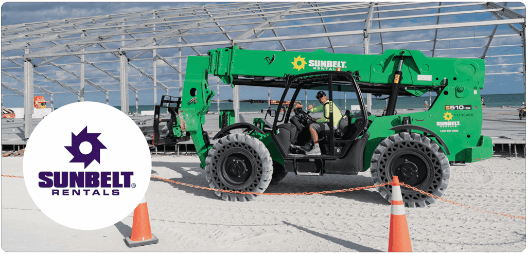 A construction scene on a beach. A worker operates a large green Sunbelt Rentals machine in front of a metal frame structure, with the ocean in the background. The left side of the image features a white circle containing the Sunbelt Rentals logo.