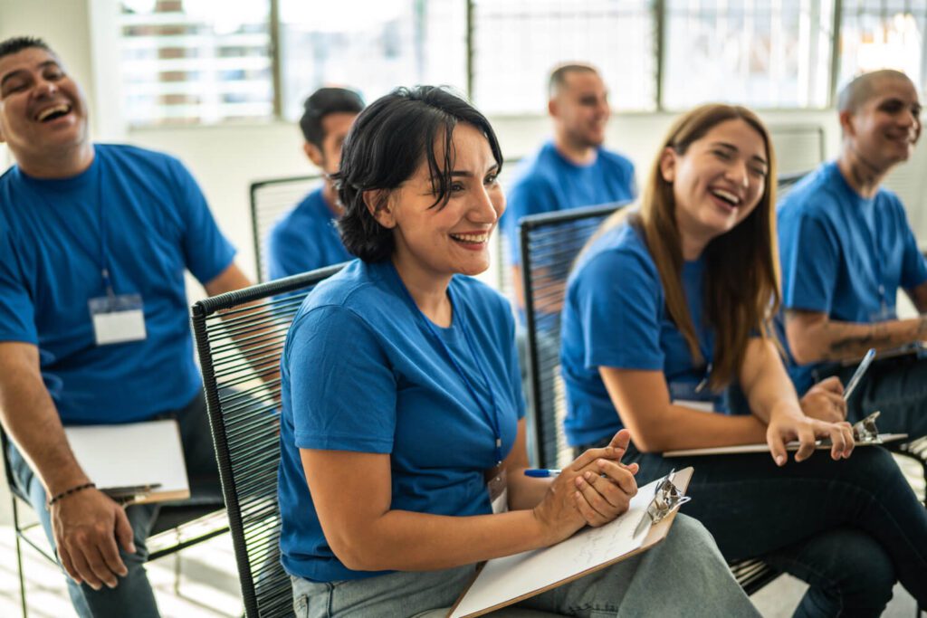 Volunteers paying attention and smiling on a community center presentation