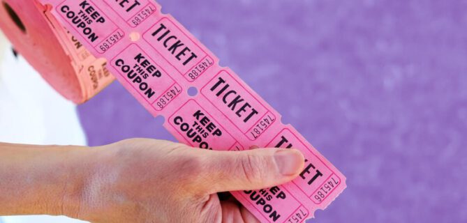 A photo of someone holding raffle tickets.