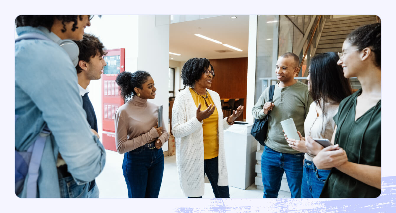 A photo of a group of college students in a school lobby.