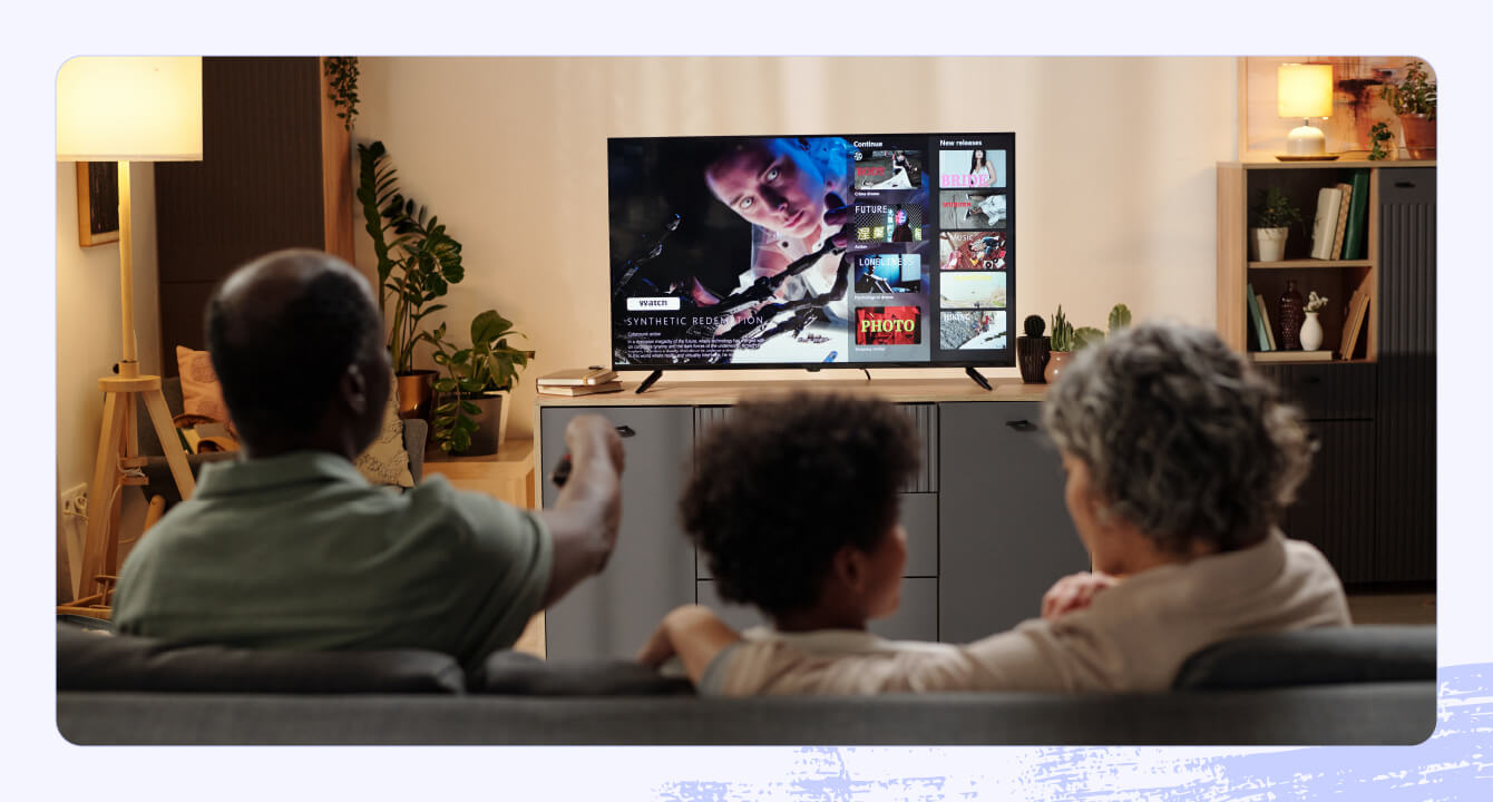 A photo of a family watching a streaming service on their TV.