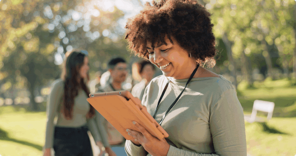A woman interacts with a tablet at a volunteer event